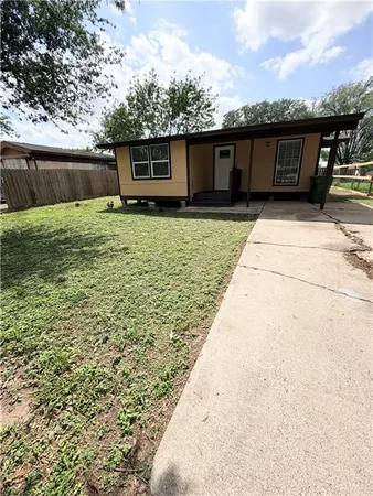 a view of a house with a backyard