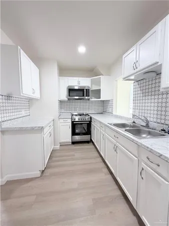 a large kitchen with a stove top oven