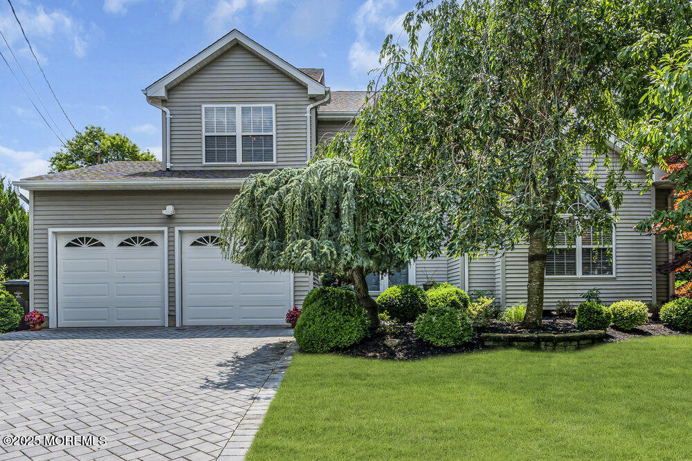 32 Tilton Road Brick, NJ 08723 - Photo 1 of 100 a front view of a house with a yard and garage