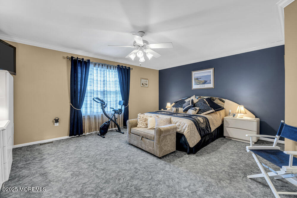32 Tilton Road Brick, NJ 08723 - Photo 51 of 100 a spacious bedroom with a bed and a chandelier