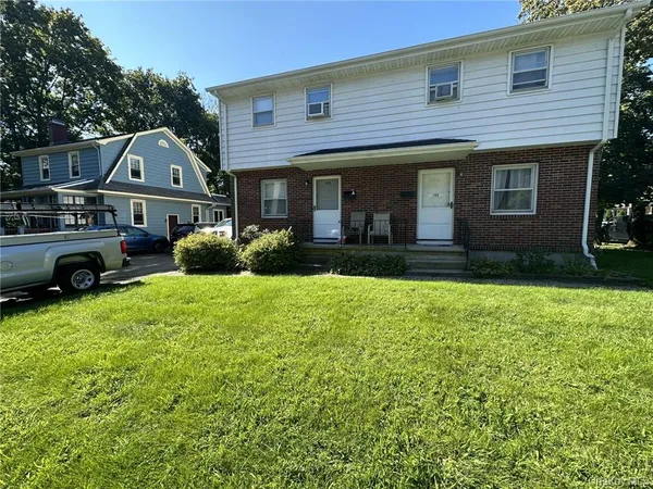 a front view of a house with a yard
