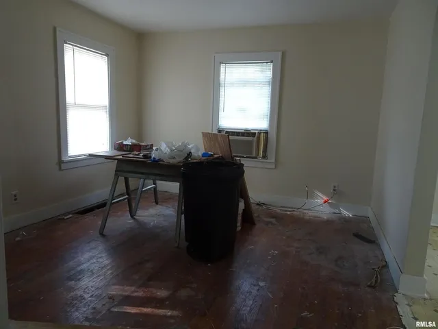 a workspace with wooden floor and a window