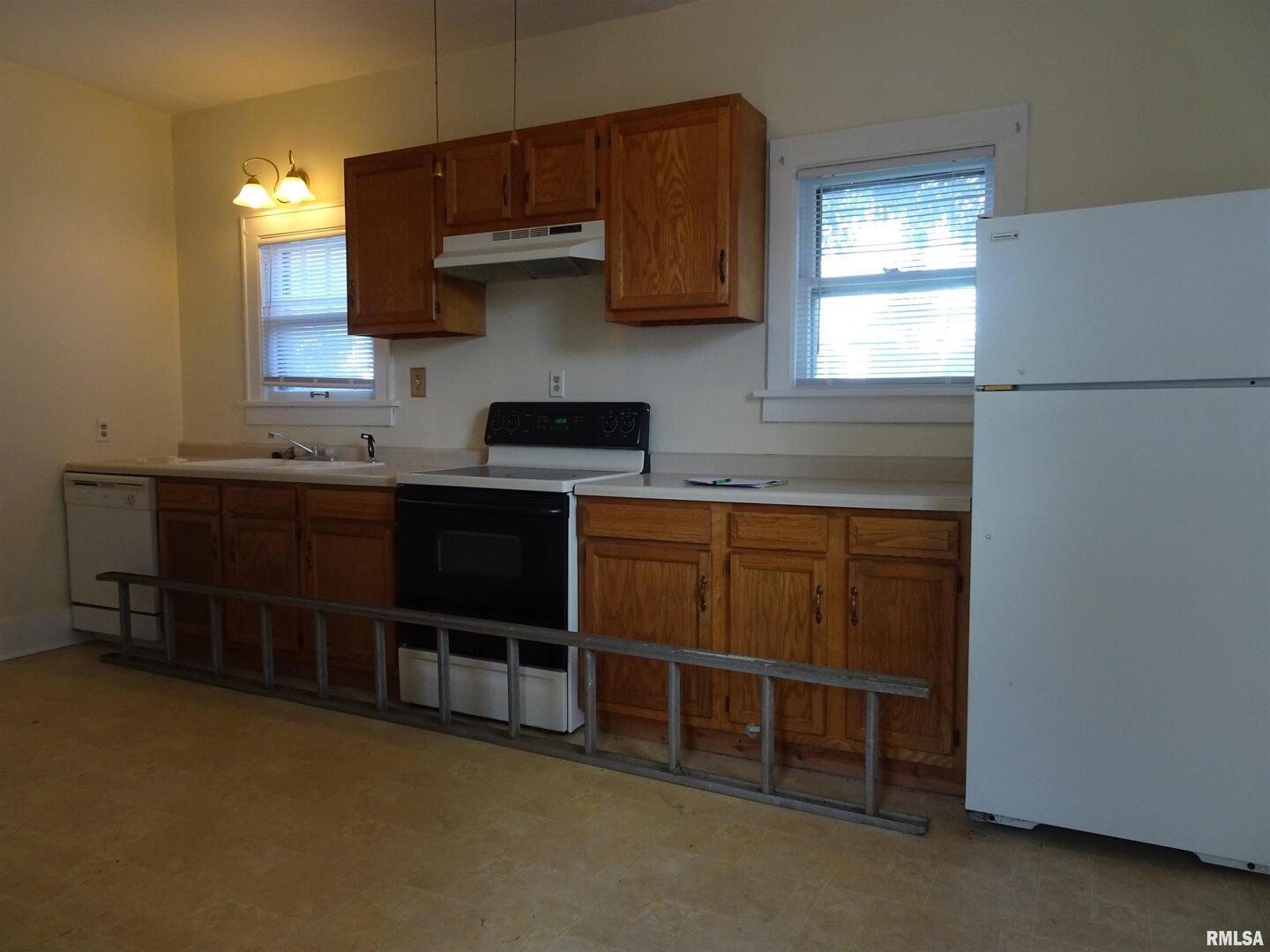917 3rd Street Silvis, IL 61282 - Photo 3 of 22 a kitchen with stainless steel appliances a stove and a refrigerator