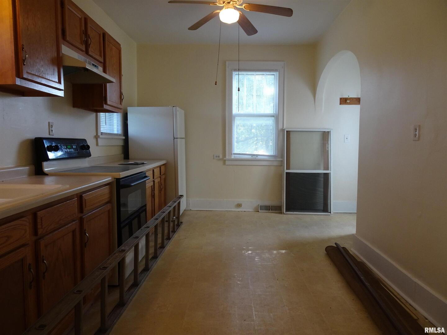 917 3rd Street Silvis, IL 61282 - Photo 4 of 22 a kitchen with stainless steel appliances granite countertop a sink a stove top oven a chimney and a refrigerator