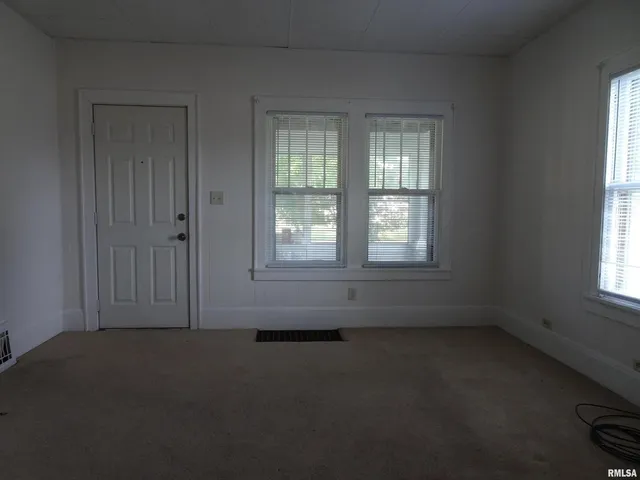 an empty room with a empty space and windows