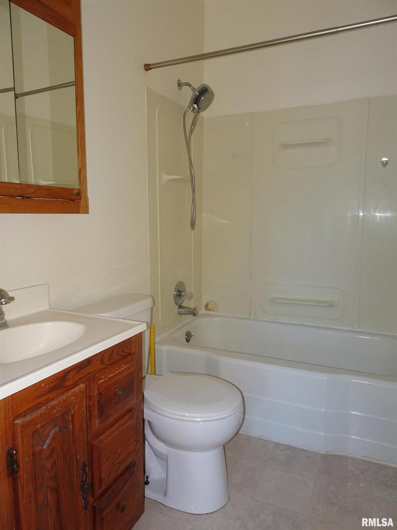 917 3rd Street Silvis, IL 61282 - Photo 8 of 22 a bathroom with a sink a toilet and shower