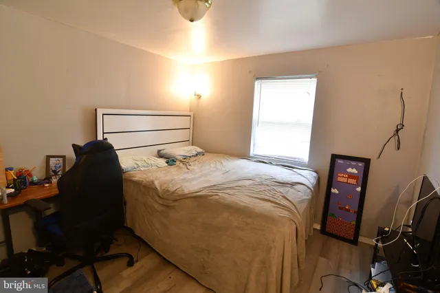 a bedroom with a bed and a window