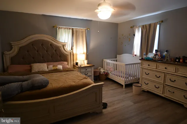 a bedroom with a bed window and a dresser