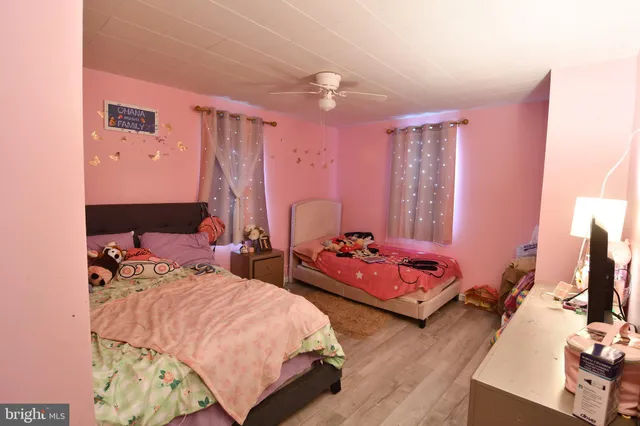 a bedroom with bed and a large mirror