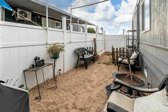 a backyard of a house with table and chairs