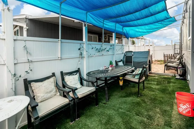 a backyard of a house with outdoor seating
