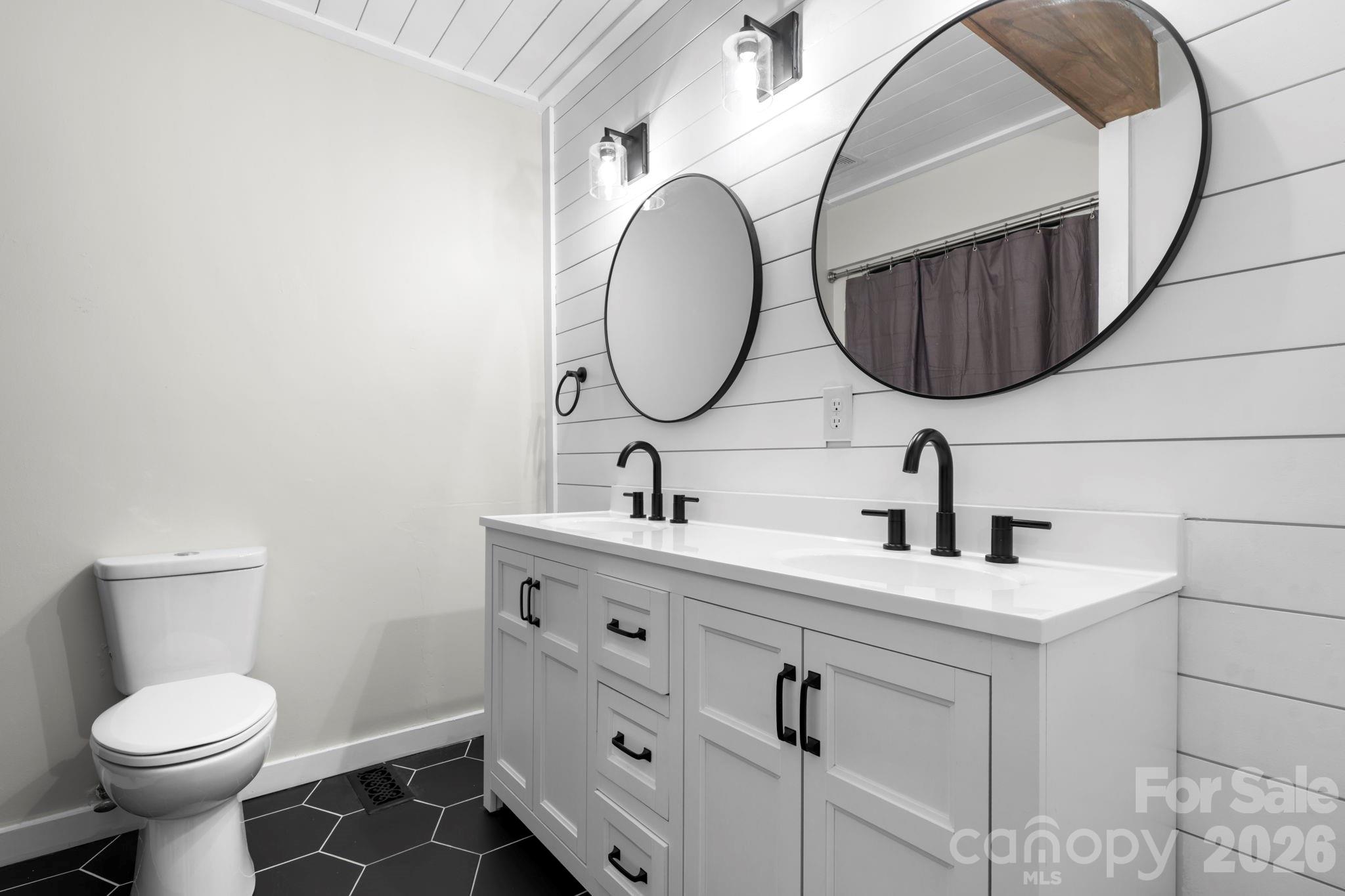 2705 North Center Street, Unit 60 Hickory, NC 28601 - Photo 15 of 27 a bathroom with a toilet sink and mirror
