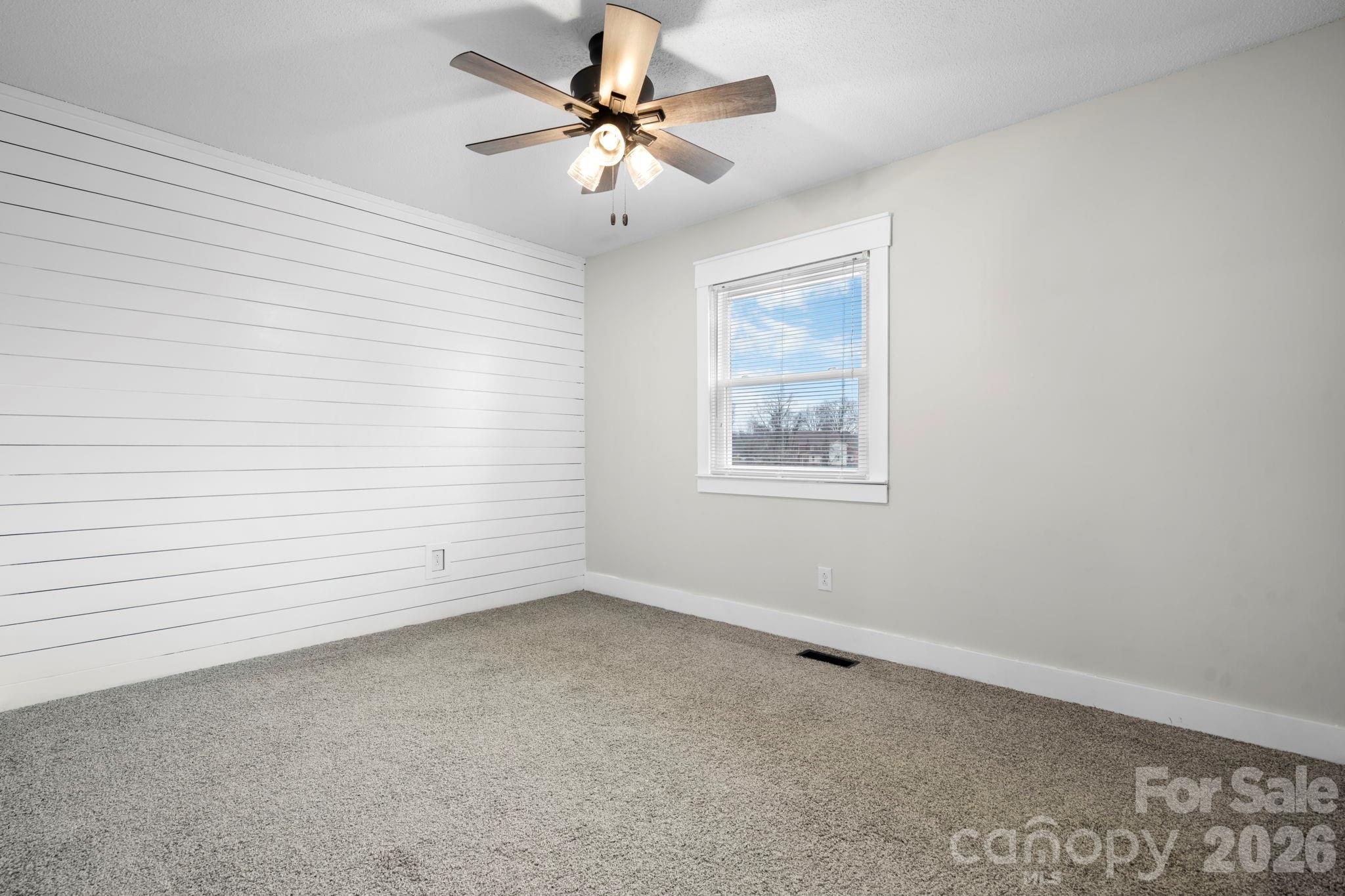 2705 North Center Street, Unit 60 Hickory, NC 28601 - Photo 16 of 27 wooden floor in an empty room with a window