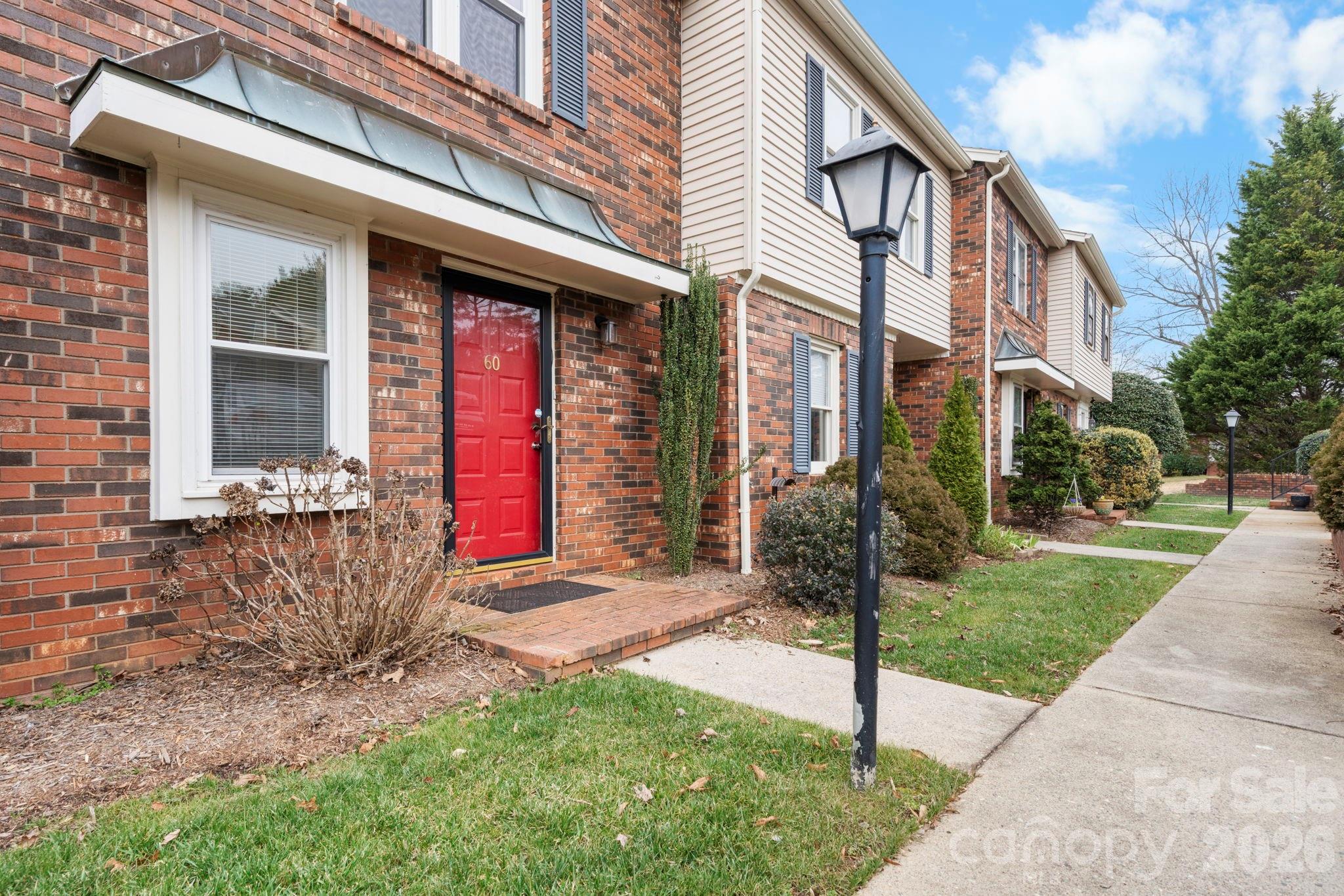 2705 North Center Street, Unit 60 Hickory, NC 28601 - Photo 2 of 27 a front view of a house with a yard