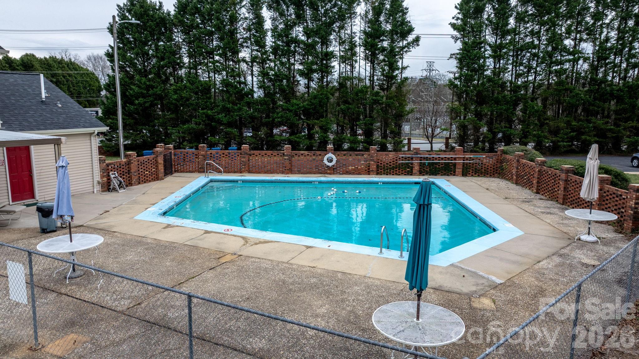 2705 North Center Street, Unit 60 Hickory, NC 28601 - Photo 27 of 27 a view of a swimming pool with a patio and fire pit