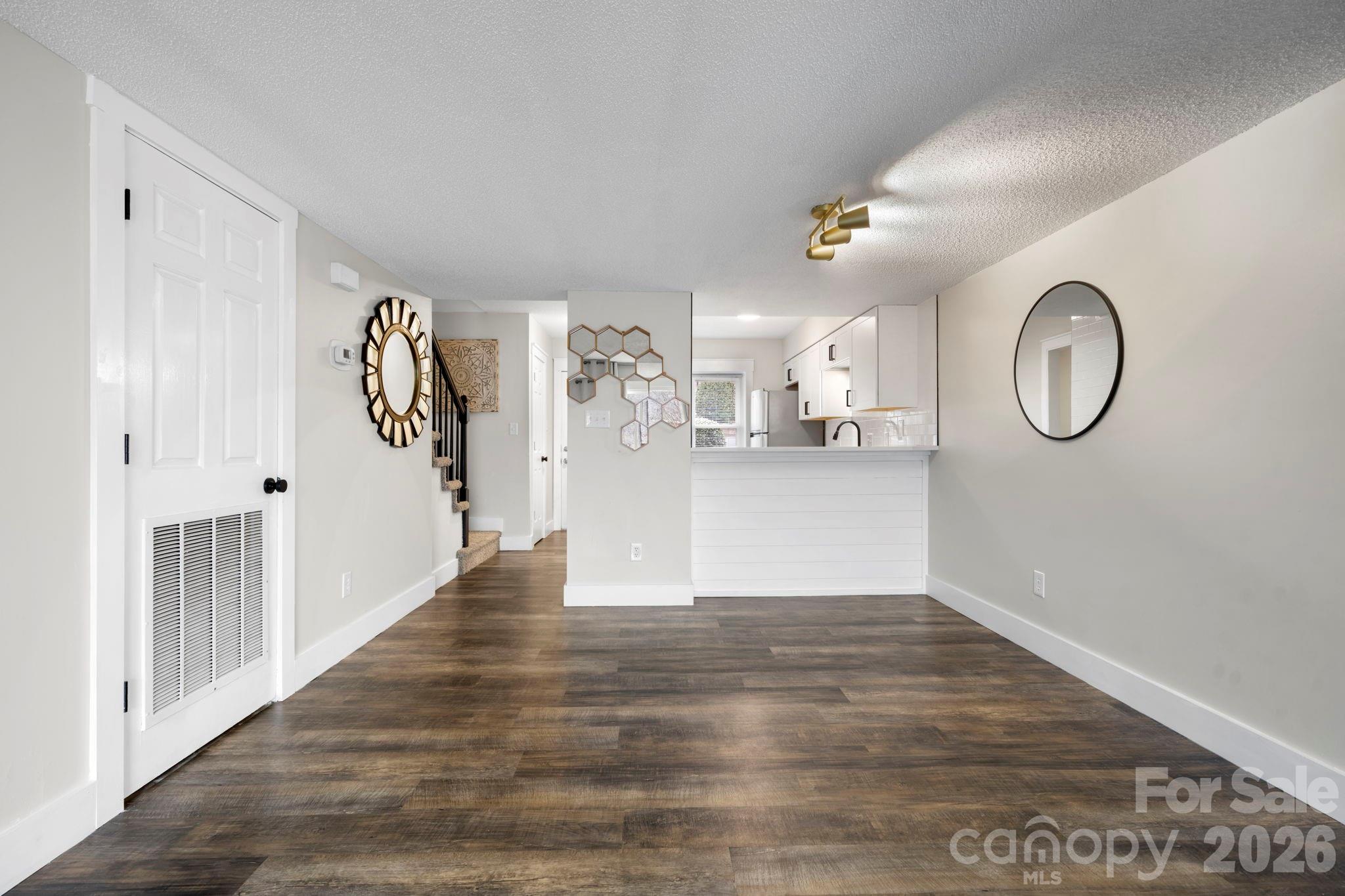 2705 North Center Street, Unit 60 Hickory, NC 28601 - Photo 8 of 27 a view of a room with wooden floor and white walls