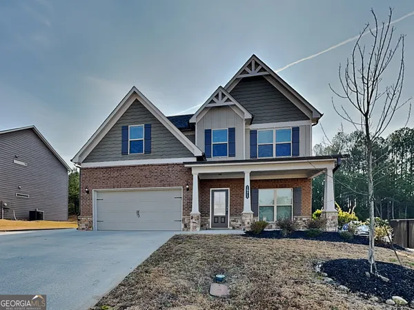 a front view of a house with garden