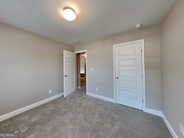 an empty room with closet area