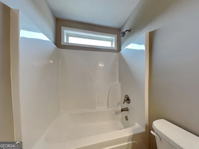 a bathroom with a bathtub and a toilet