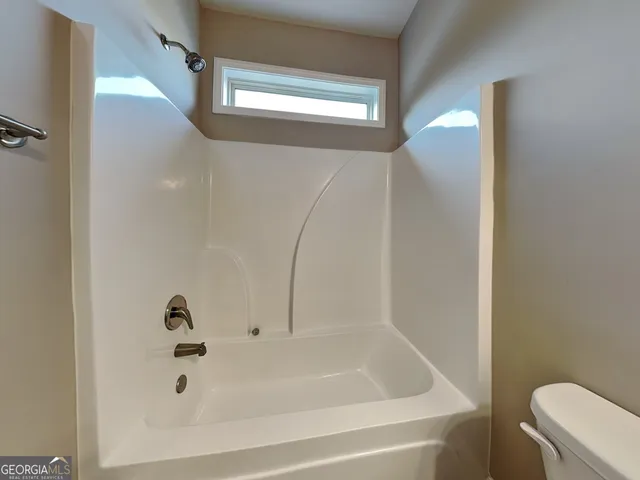 a bathroom with a tub and a shower