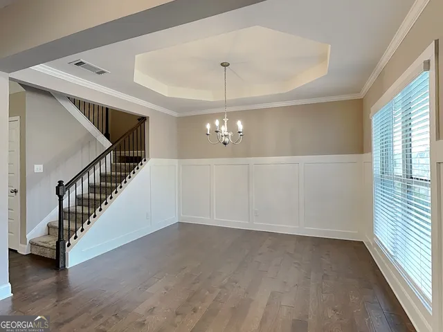 a view of an entryway with wooden floor