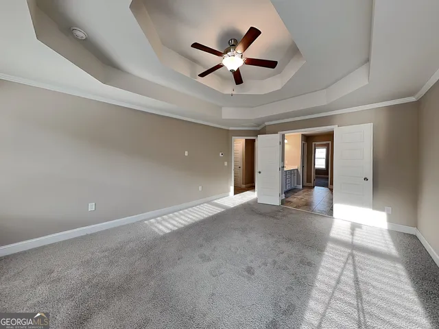 a view of a livingroom with a ceiling fan and wooden floor