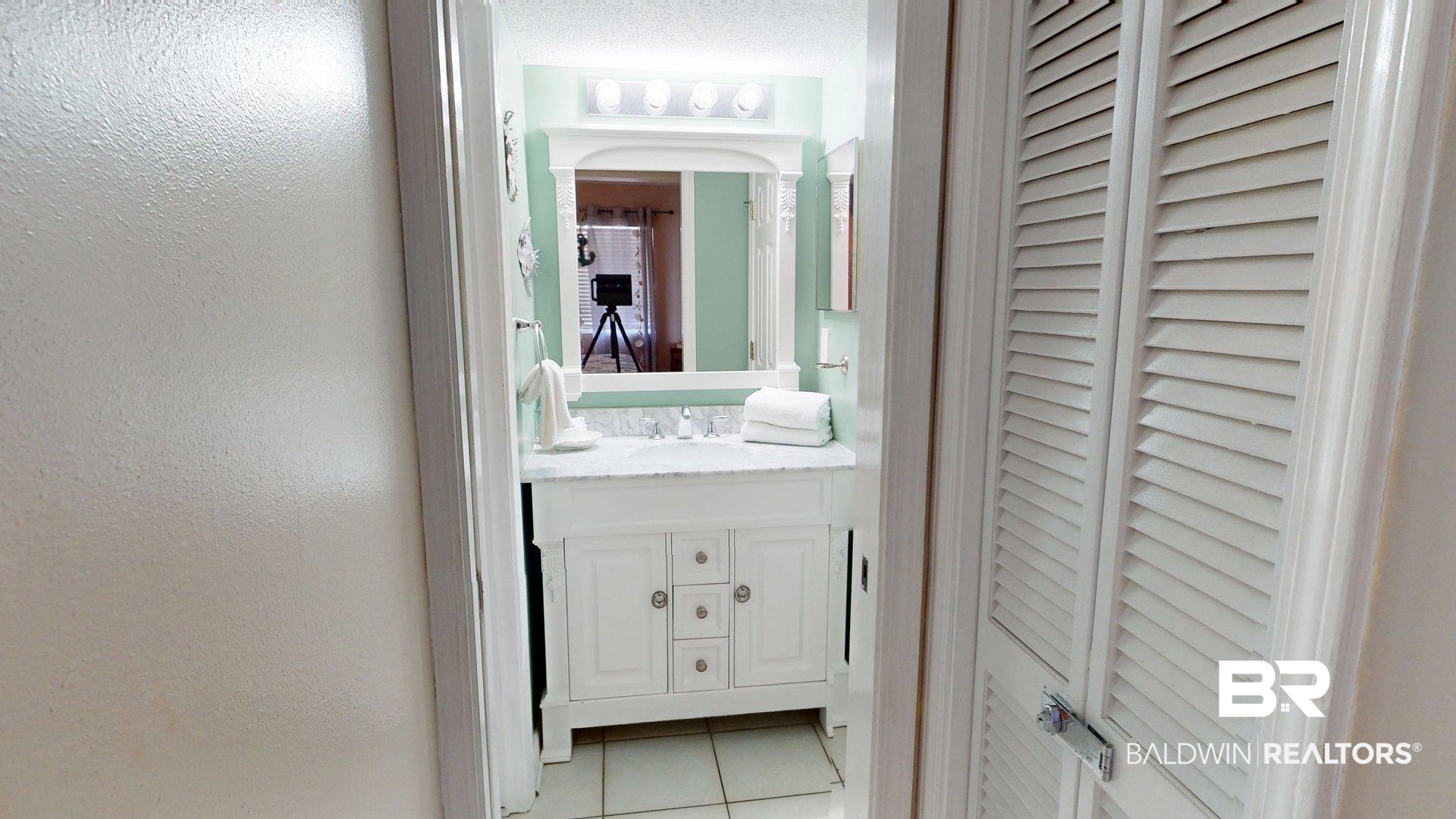 645 Plantation Road, Unit 6503 Gulf Shores, AL 36542 - Photo 49 of 53 Half bathroom featuring a closet, light tile patterned floors, vanity, a textured wall, and a textured ceiling