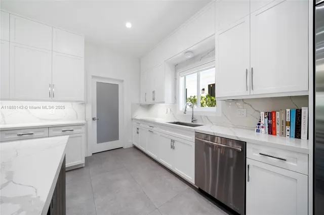 a kitchen with white cabinets and white appliances