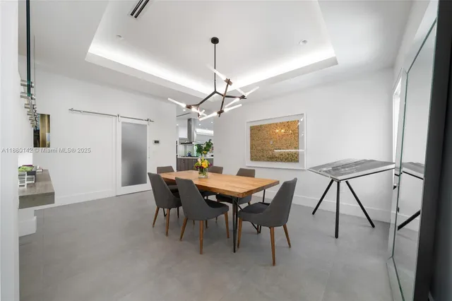 a view of a dining room with furniture and window