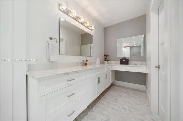 a bathroom with a sink a mirror and a bathtub