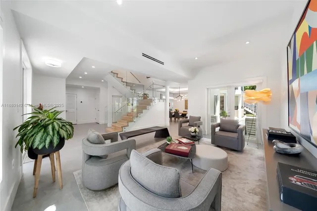a living room with furniture and a potted plant