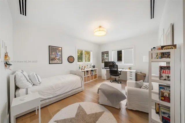a living room with furniture and a book shelf