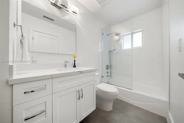 a bathroom with a double vanity sink toilet and shower