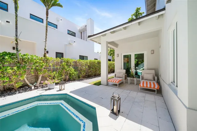 a view of a patio with couches table and chairs and potted plants