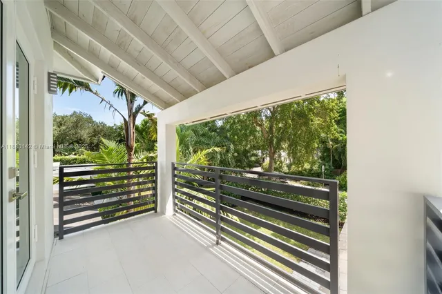 a view of a room with wooden floor and windows
