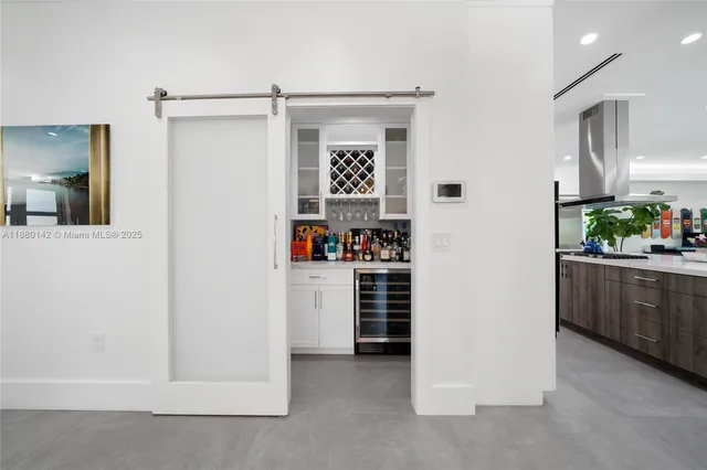 a view of kitchen with refrigerator and window