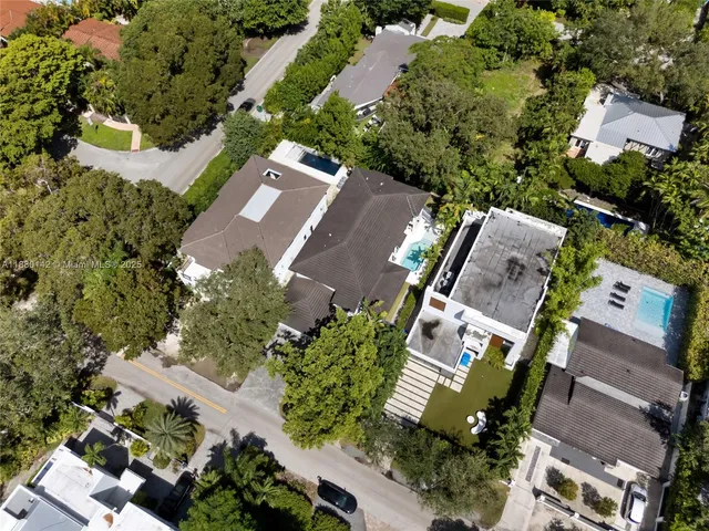 an aerial view of residential houses with outdoor space