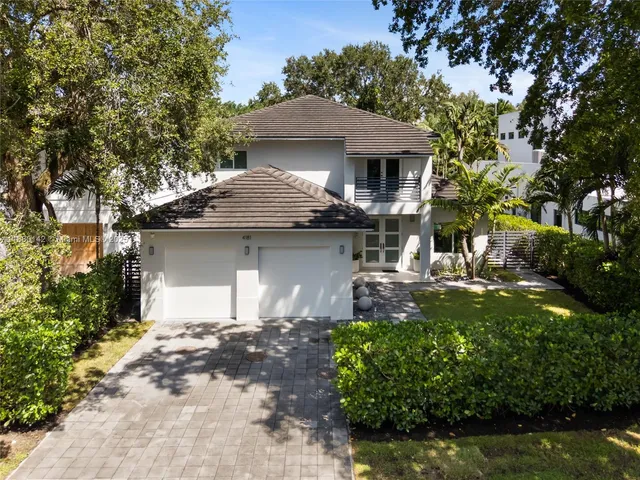 a front view of a house with a yard garage and outdoor seating