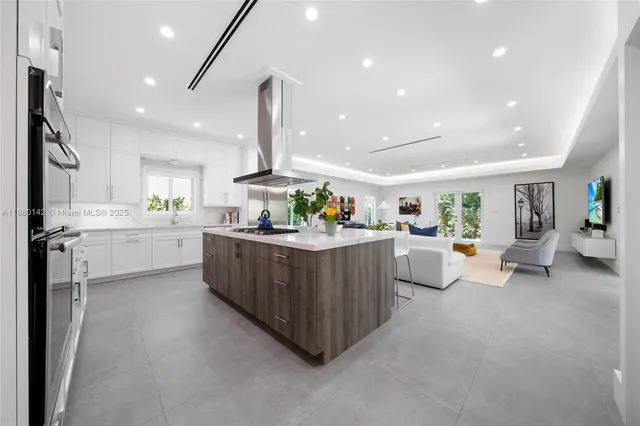 a living room with furniture and a kitchen