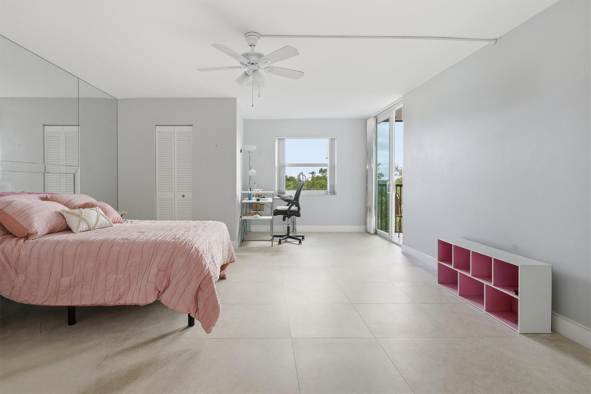 3910 Inverrary Boulevard, Unit 708B Lauderhill, FL 33319 - Photo 21 of 58 a spacious bedroom with a bed and a chandelier