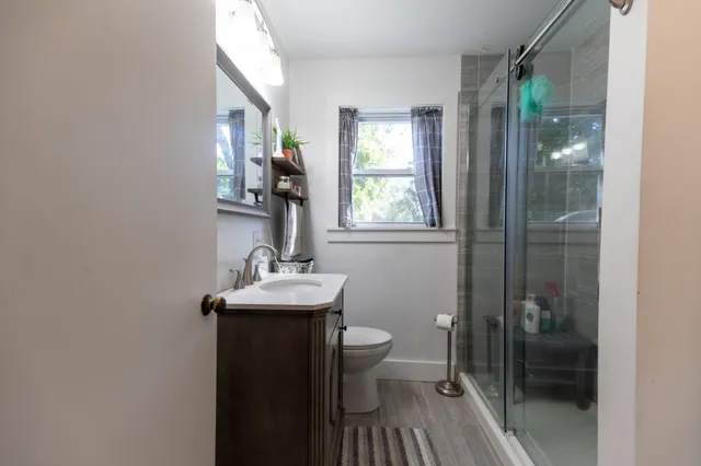 a bathroom with a sink toilet and shower