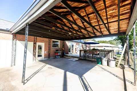a view of a porch with furniture and a patio