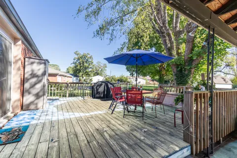 a view of a chairs and table on the wooden deck