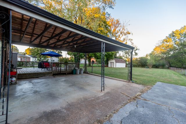 a view of a deck with furniture and a yard