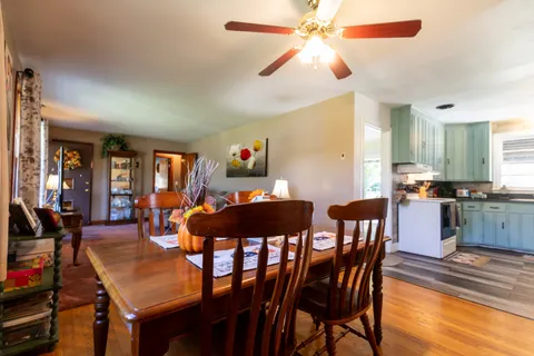 a view of a dining room with furniture and wooden floor