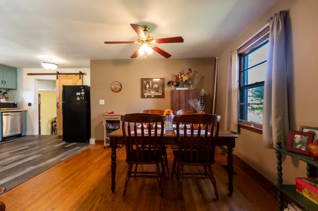 a view of a dining room with furniture and wooden floor