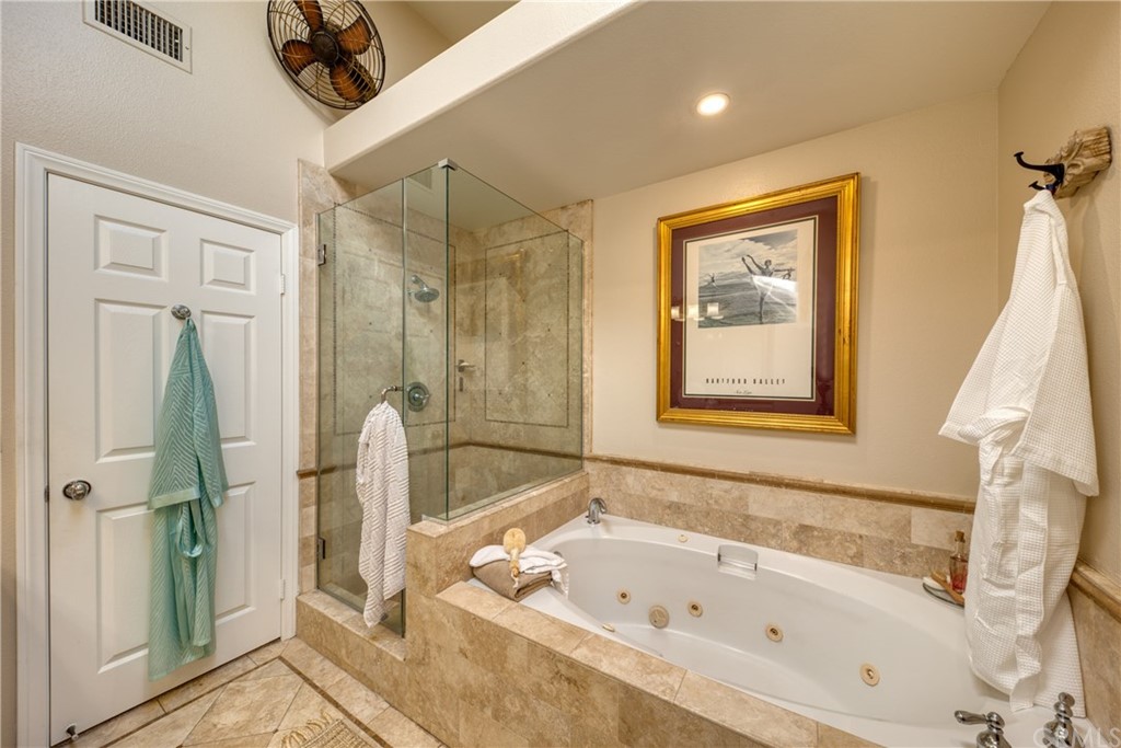 200 North Sunset Place Monrovia, CA 91016 - Photo 17 of 44 a bathroom with a tub a sink and glass door shower
