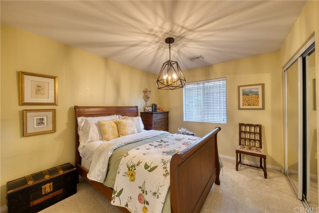 200 North Sunset Place Monrovia, CA 91016 - Photo 18 of 44 a bed room with a bed and a chandelier