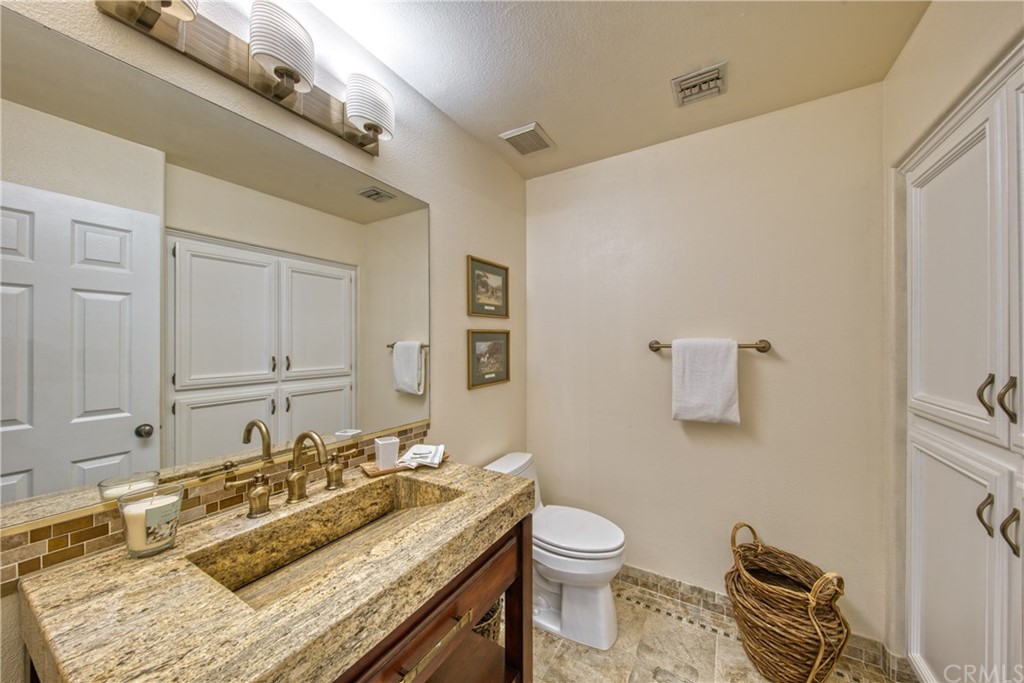 200 North Sunset Place Monrovia, CA 91016 - Photo 19 of 44 a bathroom with a granite countertop sink and a mirror