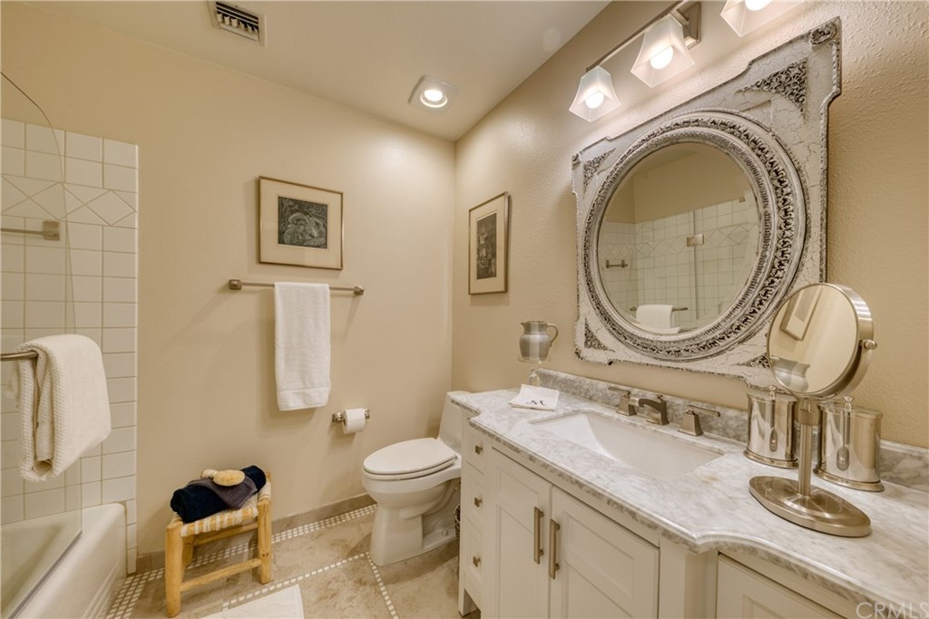 200 North Sunset Place Monrovia, CA 91016 - Photo 21 of 44 a bathroom with a granite countertop double vanity sink a mirror and a toilet